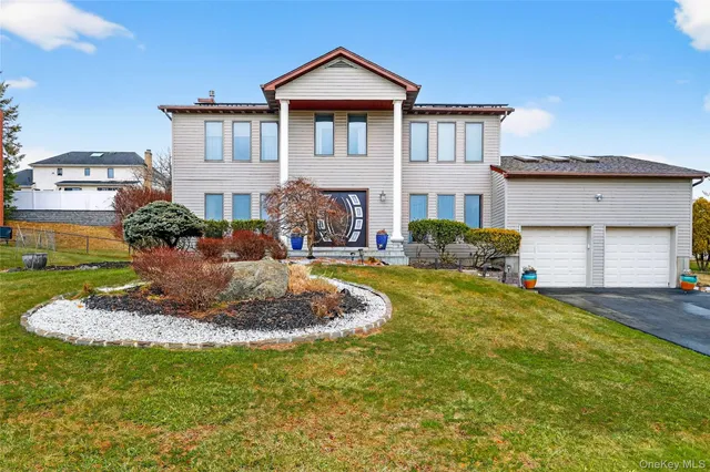 a front view of a house with garden