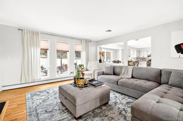 a living room with furniture a rug and a large window