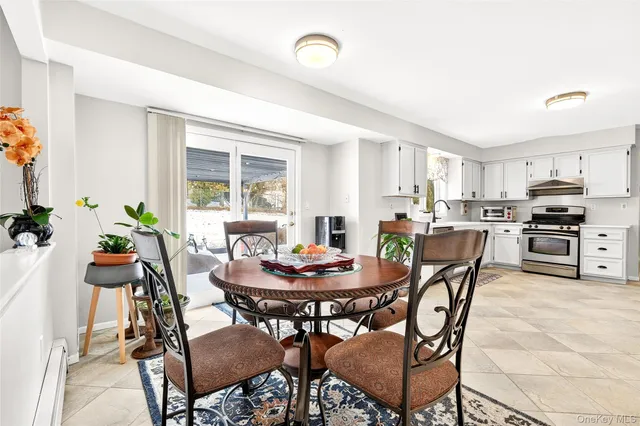 a kitchen with a sink and chairs