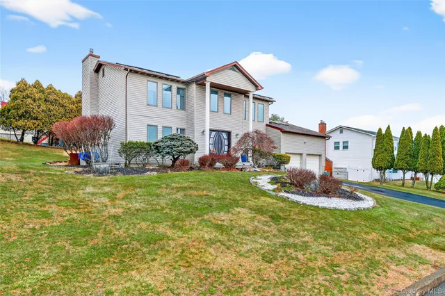 a front view of house with yard and outdoor seating
