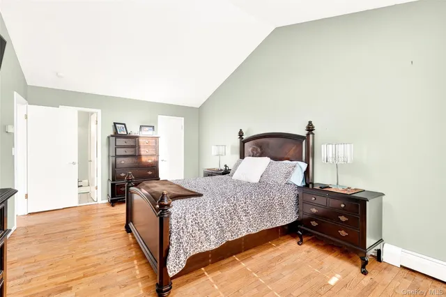 a bedroom with furniture and a large window