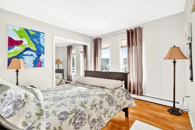 a bedroom with a bed and a painting on the wall