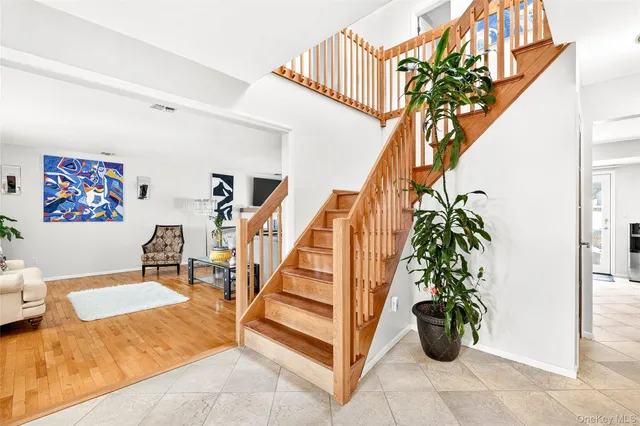 a living room with furniture and view of kitchen