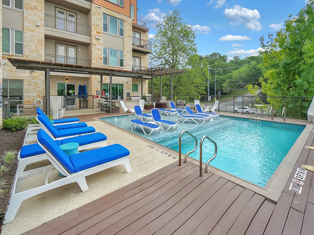 1900 Barton Springs Road, Unit 4013A Austin, TX 78704 - Photo 16 of 31 a view of pool with lawn chairs and wooden fence