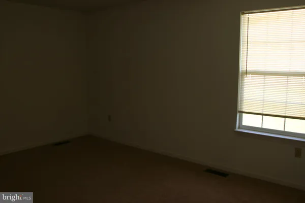 a view of a hallway with wooden floor and entryway