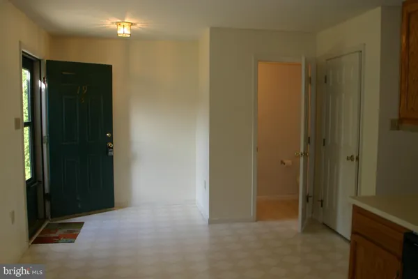 a view of hallway with a bathroom