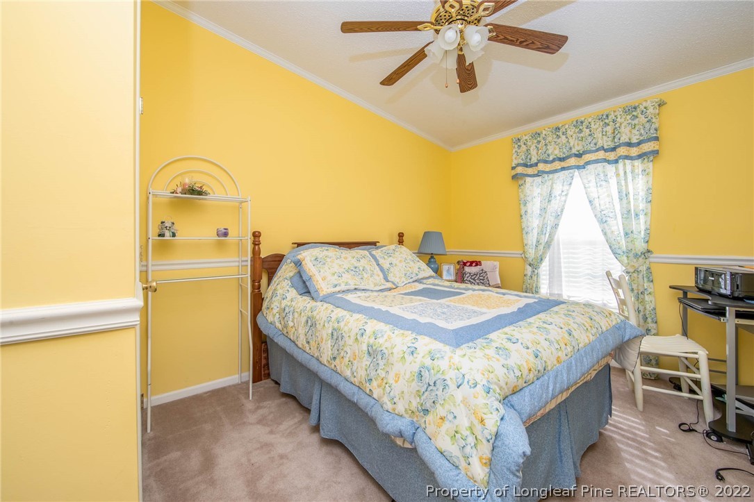 5384 Wade-Stedman Road Wade, NC 28395 - Photo 6 of 18 a bedroom with a bed and a chandelier