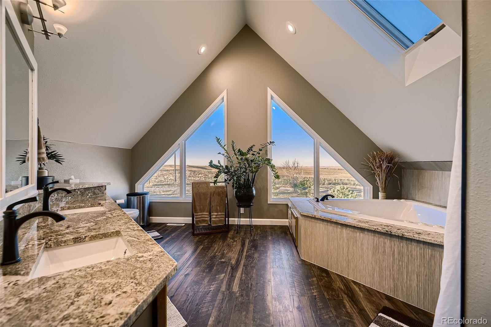28242 Stone Horse Ranch Road Elbert, CO 80106 - Photo 12 of 39 a living room with furniture stairs and a wooden floor