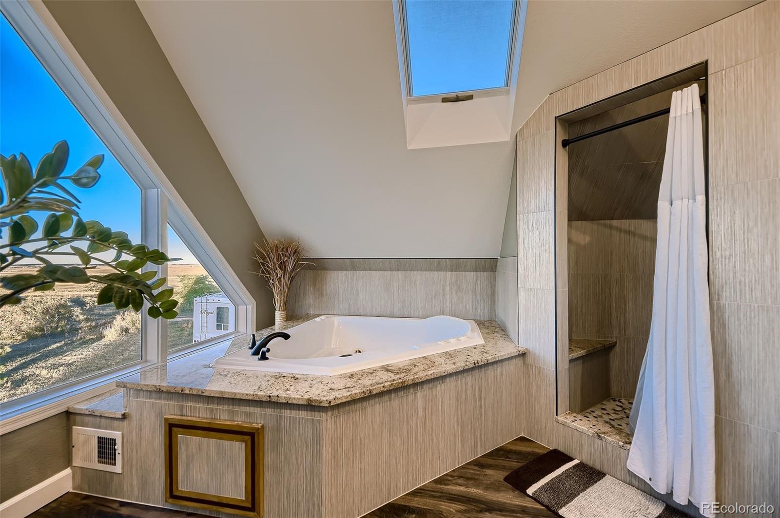 28242 Stone Horse Ranch Road Elbert, CO 80106 - Photo 13 of 39 a bathroom with a granite countertop sink and a mirror