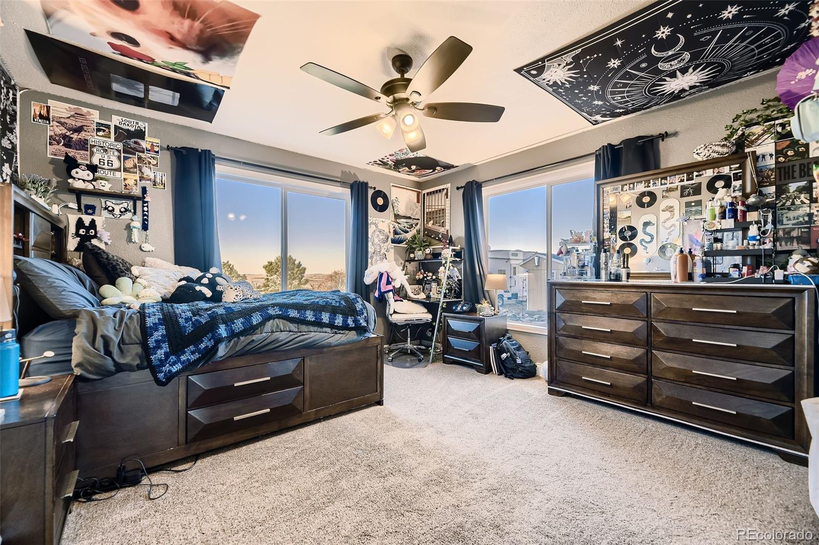 28242 Stone Horse Ranch Road Elbert, CO 80106 - Photo 14 of 39 a bed room with a bed and a ceiling fan