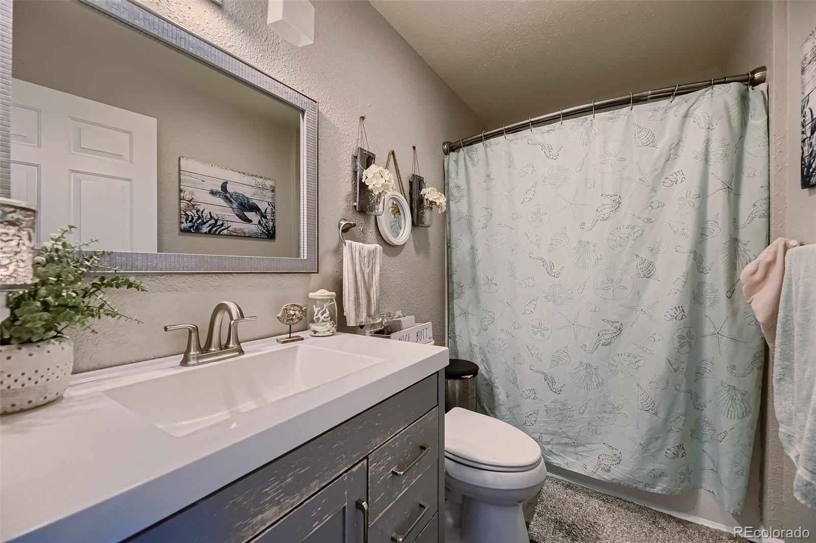 28242 Stone Horse Ranch Road Elbert, CO 80106 - Photo 15 of 39 a bathroom with a sink a toilet and a mirror