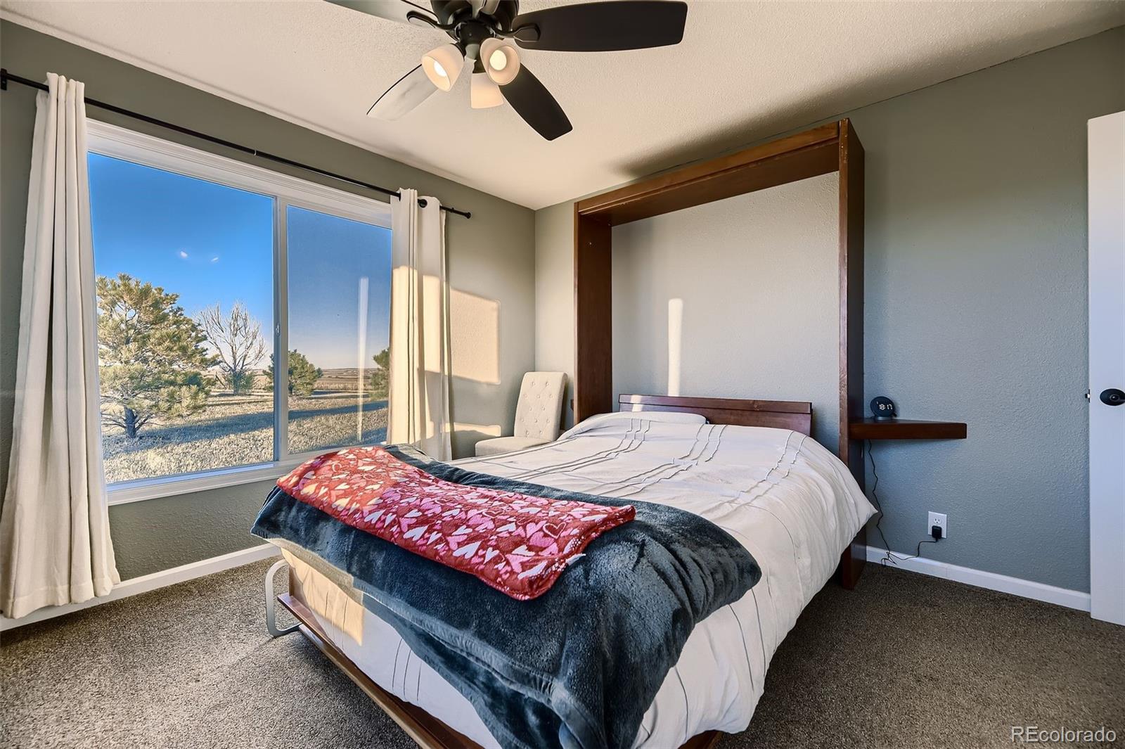28242 Stone Horse Ranch Road Elbert, CO 80106 - Photo 16 of 39 a bedroom with a bed and large window