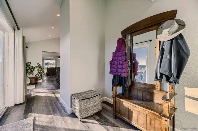 a view of a balcony with furniture and wooden floor