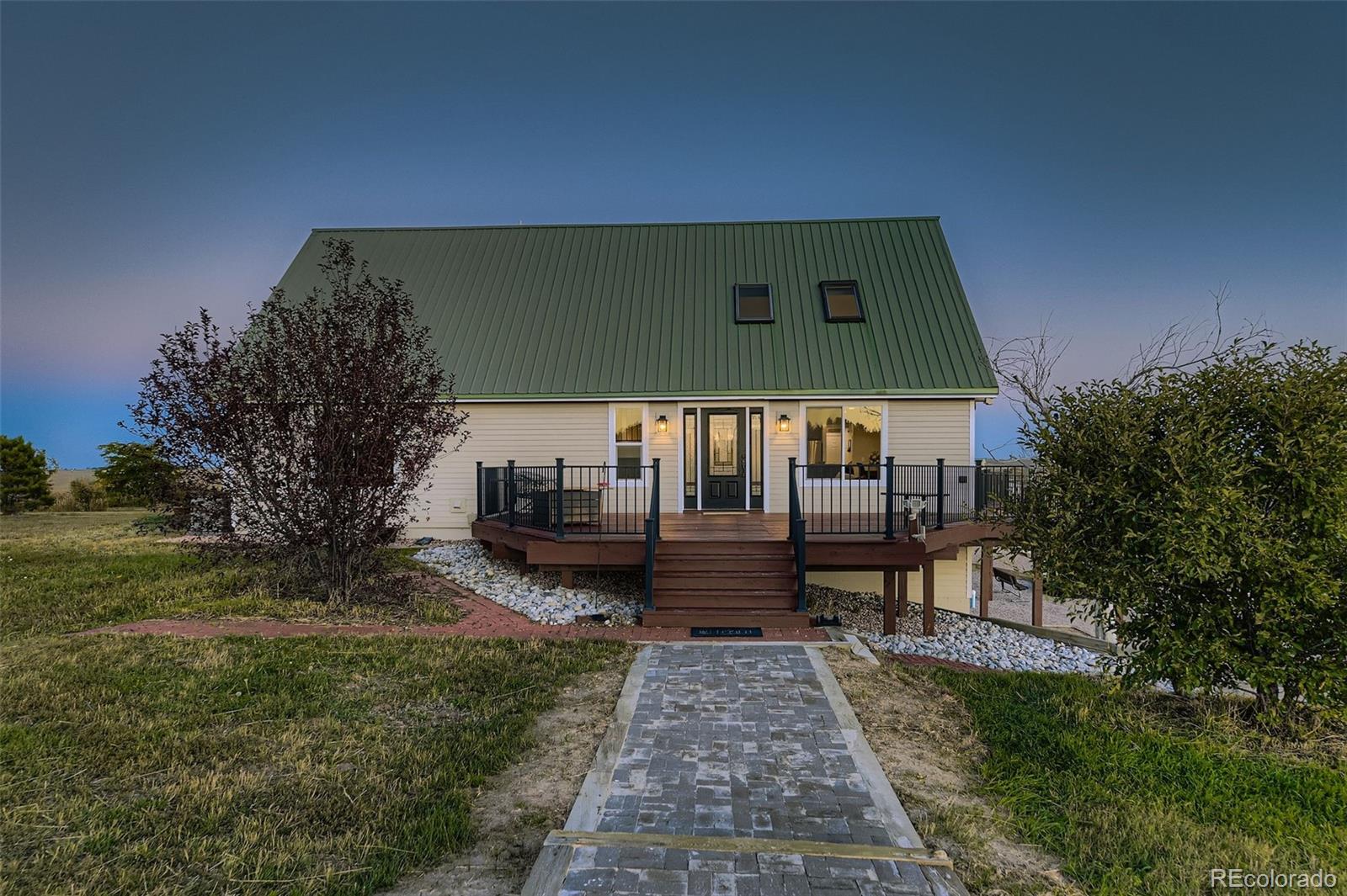 28242 Stone Horse Ranch Road Elbert, CO 80106 - Photo 2 of 39 a front view of a house with garden