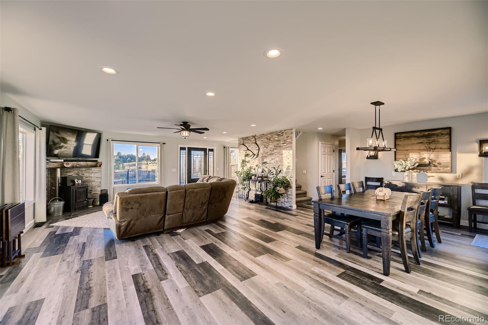 28242 Stone Horse Ranch Road Elbert, CO 80106 - Photo 6 of 39 a living room with furniture and wooden floor