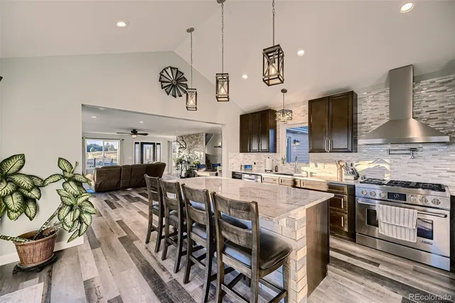 a kitchen with stainless steel appliances granite countertop a stove oven a sink a stove and a refrigerator