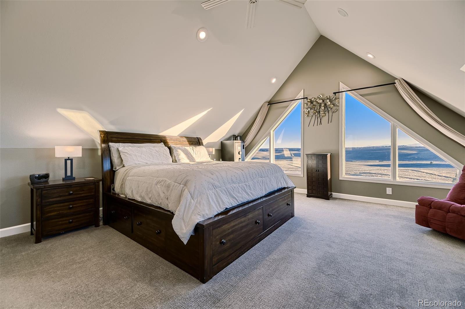 28242 Stone Horse Ranch Road Elbert, CO 80106 - Photo 10 of 39 a spacious bedroom with a bed and a view of walk in closet