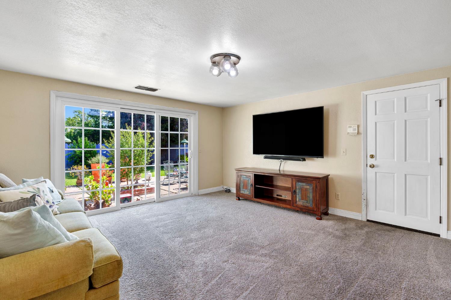 200 Lyons Street Madera, CA 93638 - Photo 20 of 32 a living room with furniture and a flat screen tv