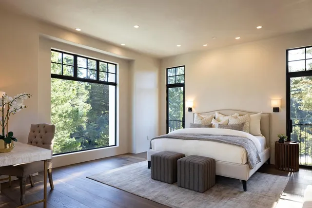 a spacious bedroom with a bed and wooden floor