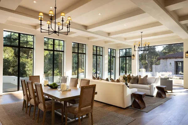 a view of a dining room with furniture large windows and wooden floor