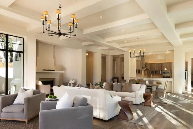 a living room with fireplace furniture and a chandelier