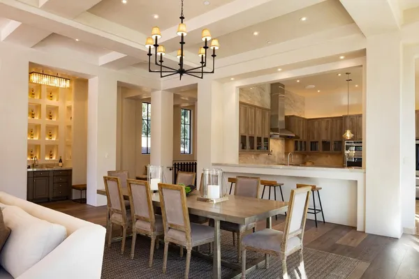 a view of a dining room with furniture wooden floor and chandelier