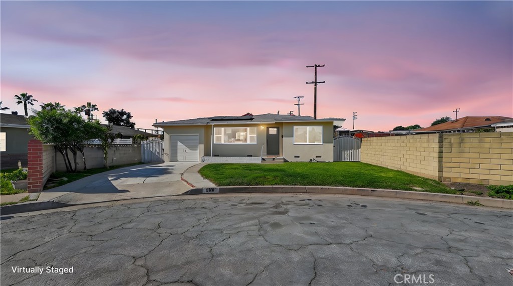 a view of a house with a yard and potted plants