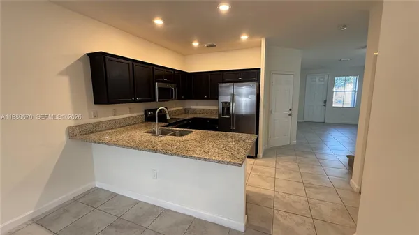 a kitchen with stainless steel appliances granite countertop a sink and cabinets