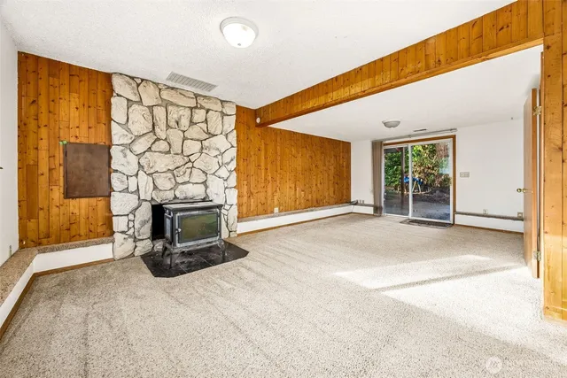 a view of a livingroom with a fireplace and window