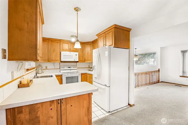 a kitchen with a refrigerator a sink and cabinets