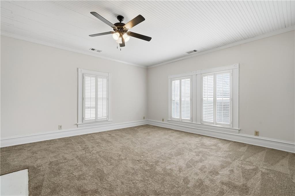 880 Johnstonville Road Barnesville, GA 30204 - Photo 21 of 33 an empty room with chandelier fan and windows