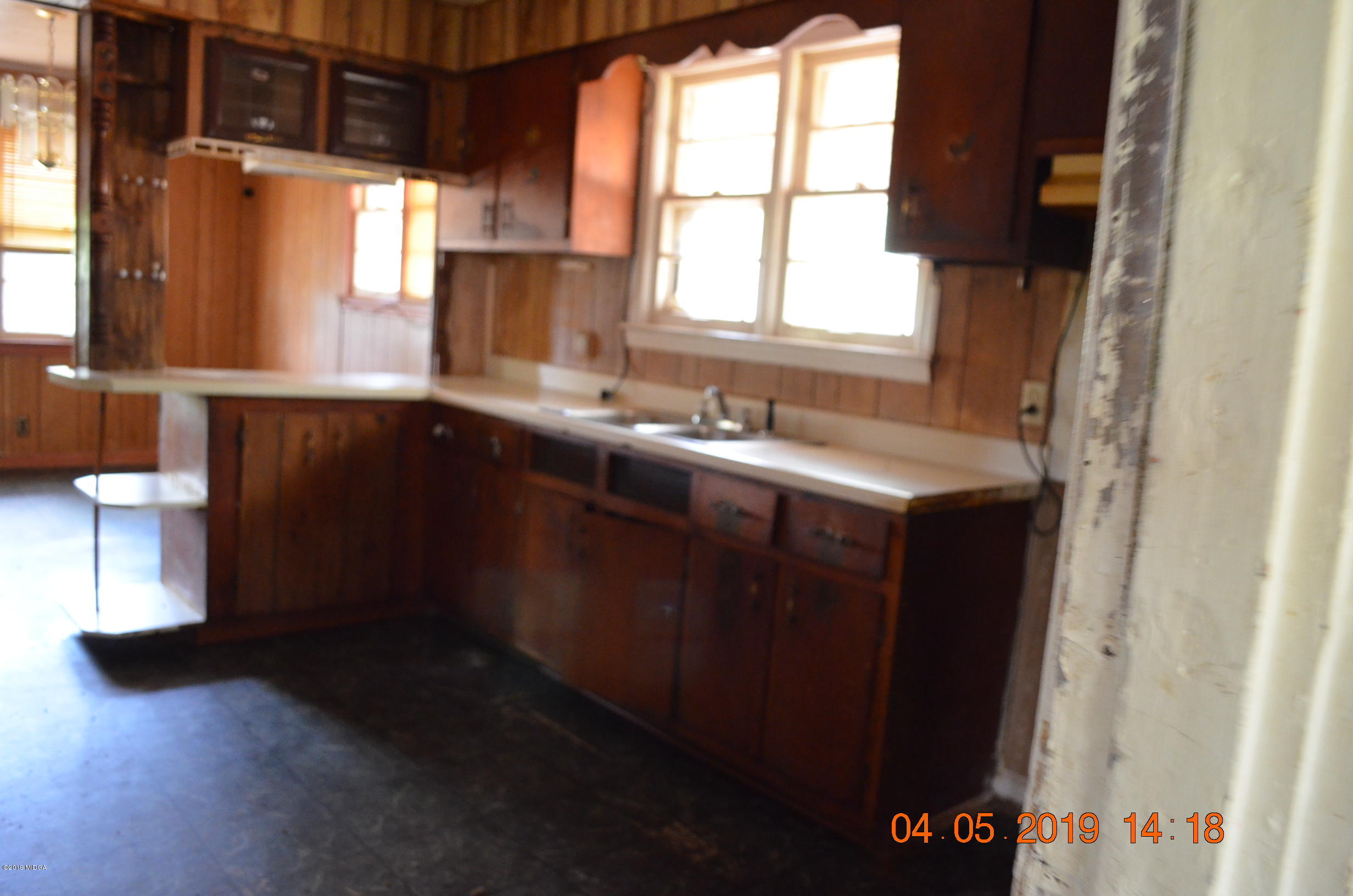 1974 Manson Road Macon, GA 31217 - Photo 3 of 15 a kitchen with a sink a window and cabinets