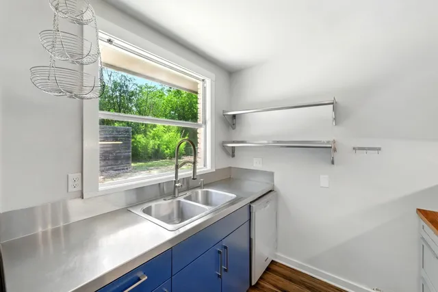 a kitchen with a sink and large window