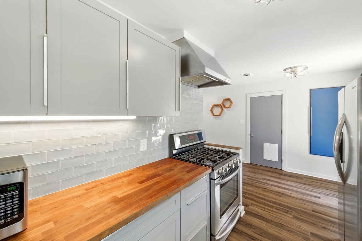 6209 Peggy Street Austin, TX 78723 - Photo 12 of 26 a kitchen with stainless steel appliances granite countertop a refrigerator and a stove