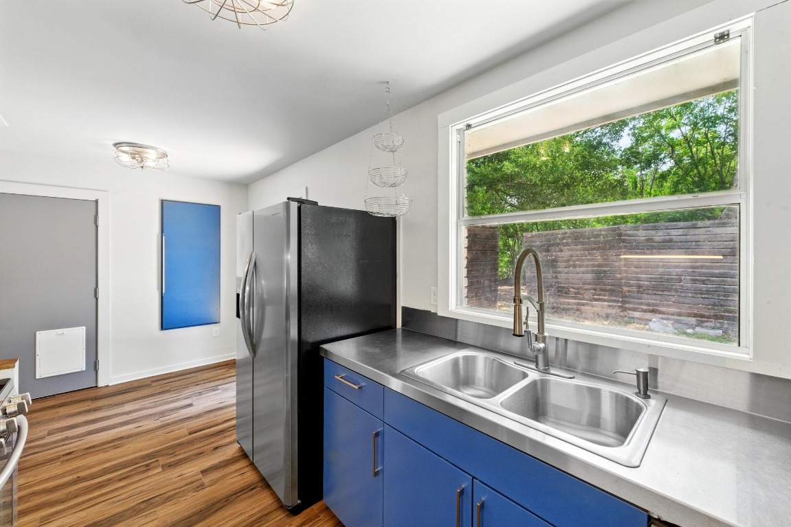 6209 Peggy Street Austin, TX 78723 - Photo 13 of 26 a kitchen with granite countertop a sink and a refrigerator