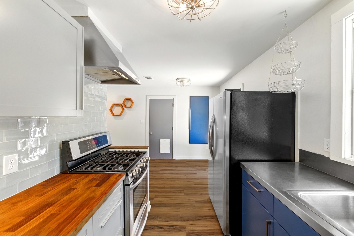 6209 Peggy Street Austin, TX 78723 - Photo 14 of 26 a kitchen with stainless steel appliances granite countertop a refrigerator and a stove