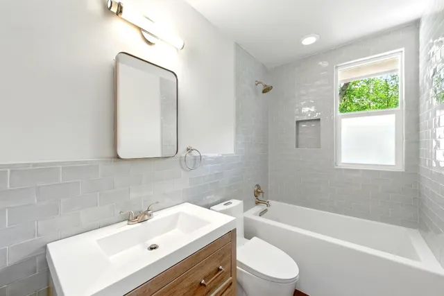 a bathroom with a sink toilet bathtub and vanity