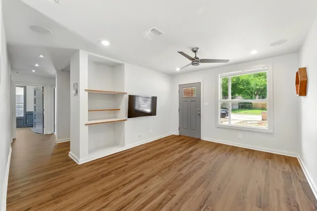 wooden floor in an empty room with a window
