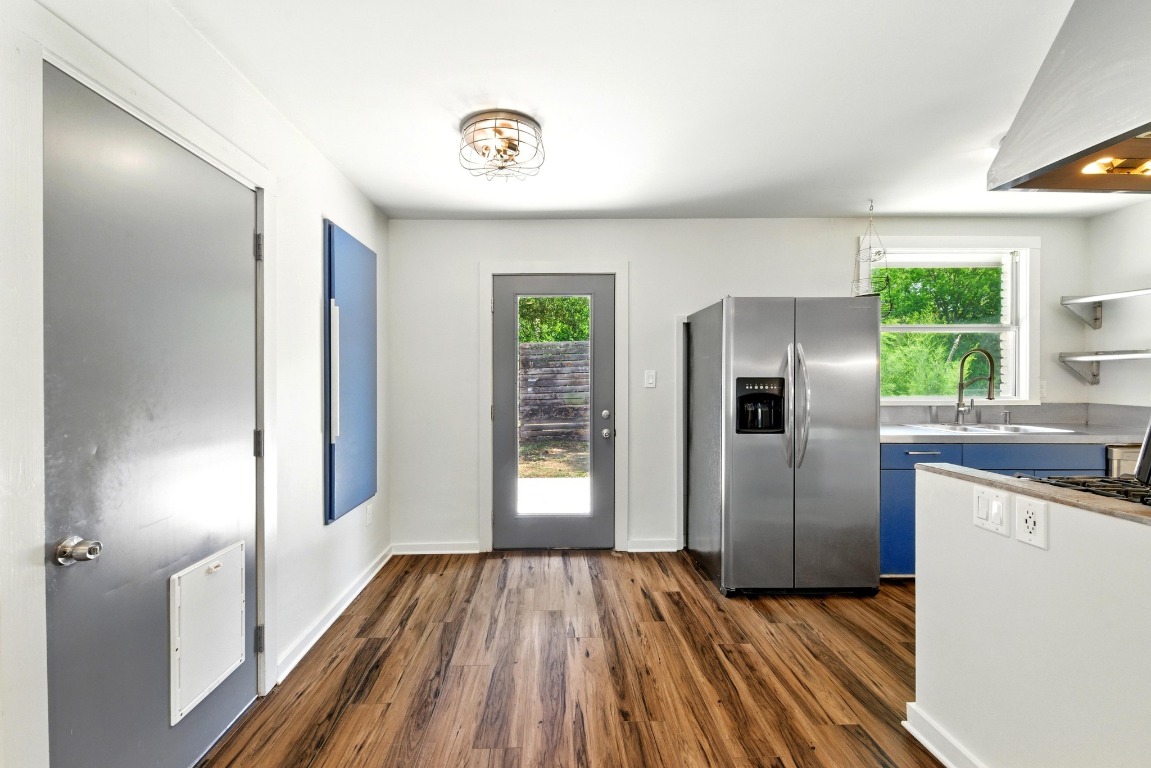 6209 Peggy Street Austin, TX 78723 - Photo 8 of 26 a kitchen with kitchen island wooden floors and refrigerator