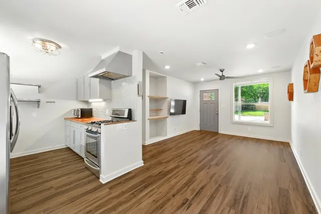 a kitchen with a wooden floor and window
