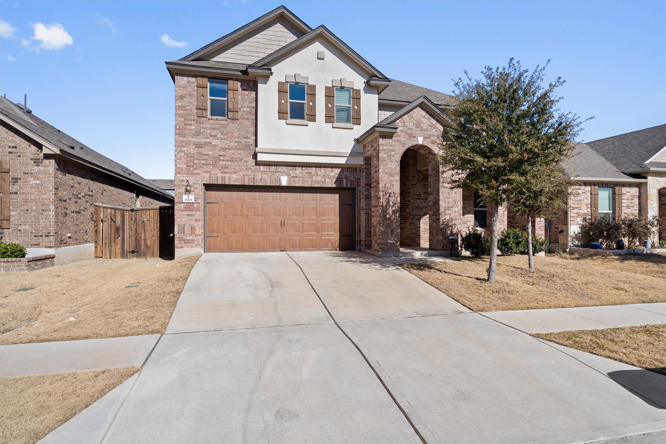 1901 Bogata Lane Leander, TX 78641 - Photo 1 of 40 View of front of property with an attached garage, driveway, brick siding, and stucco siding
