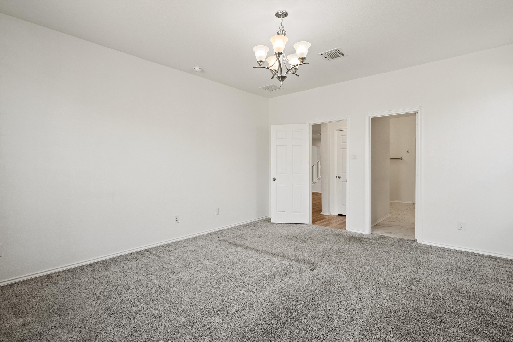 1901 Bogata Lane Leander, TX 78641 - Photo 15 of 40 Unfurnished bedroom with carpet and suspended lighting