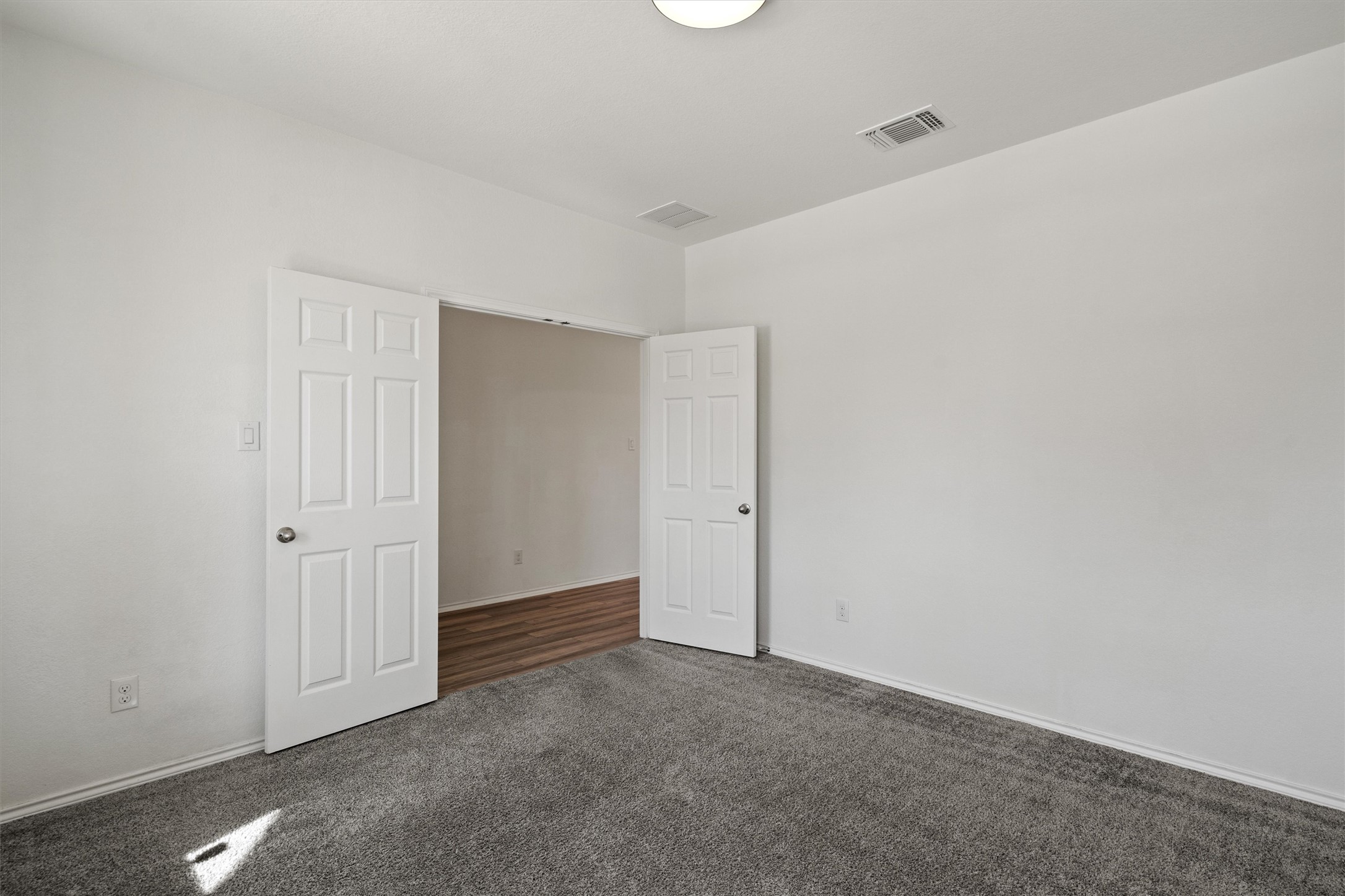 1901 Bogata Lane Leander, TX 78641 - Photo 5 of 40 Unfurnished bedroom with dark carpet and baseboards