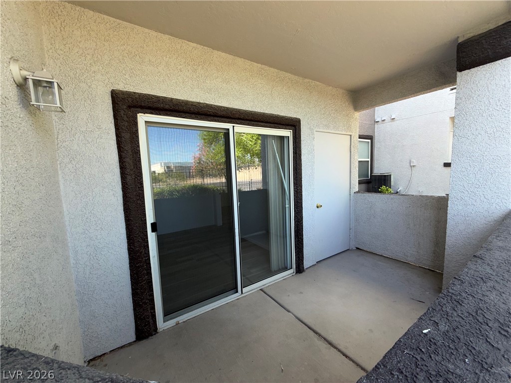 7255 West Sunset Road, Unit 1158 Las Vegas, NV 89113 - Photo 10 of 10 A compact patio space offers seamless indoor-outdoor living with a convenient sliding glass door.