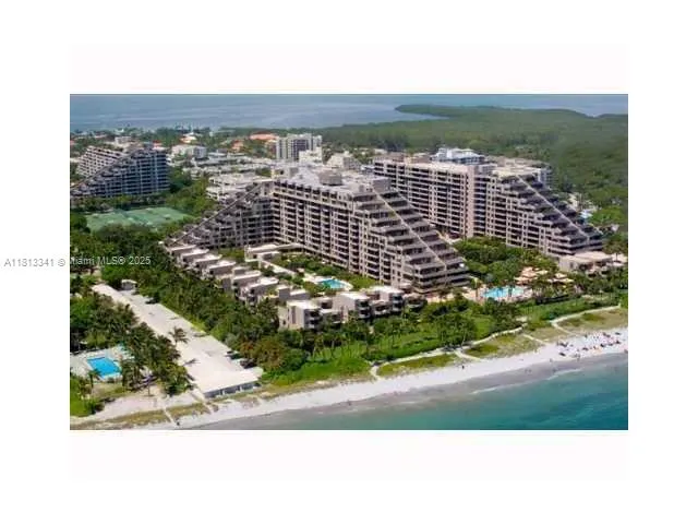a view of a livingroom with furniture and a gym cycle