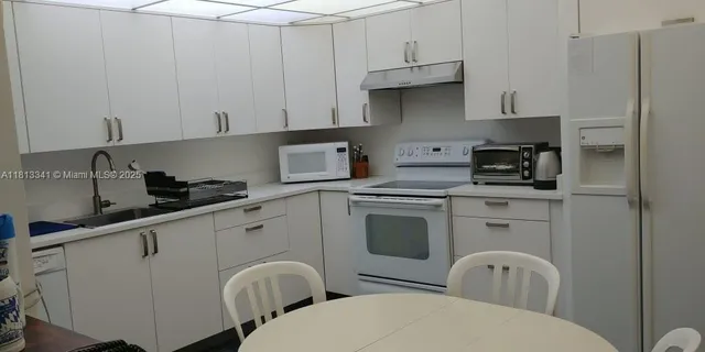 a bedroom with a bed and a dresser next to a window