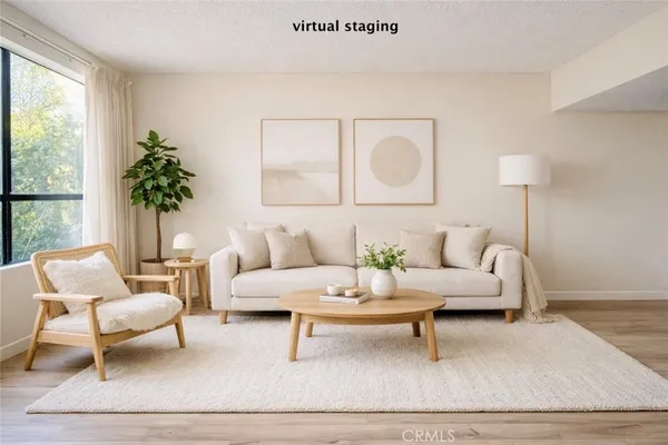 a living room with furniture and a potted plant
