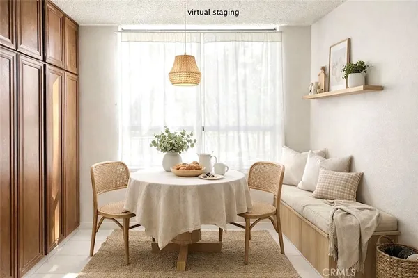 a dining room with furniture and a window