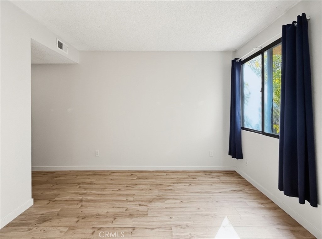415 West Duarte Road, Unit 2 Arcadia, CA 91007 - Photo 17 of 30 a view of an empty room with wooden floor and a window