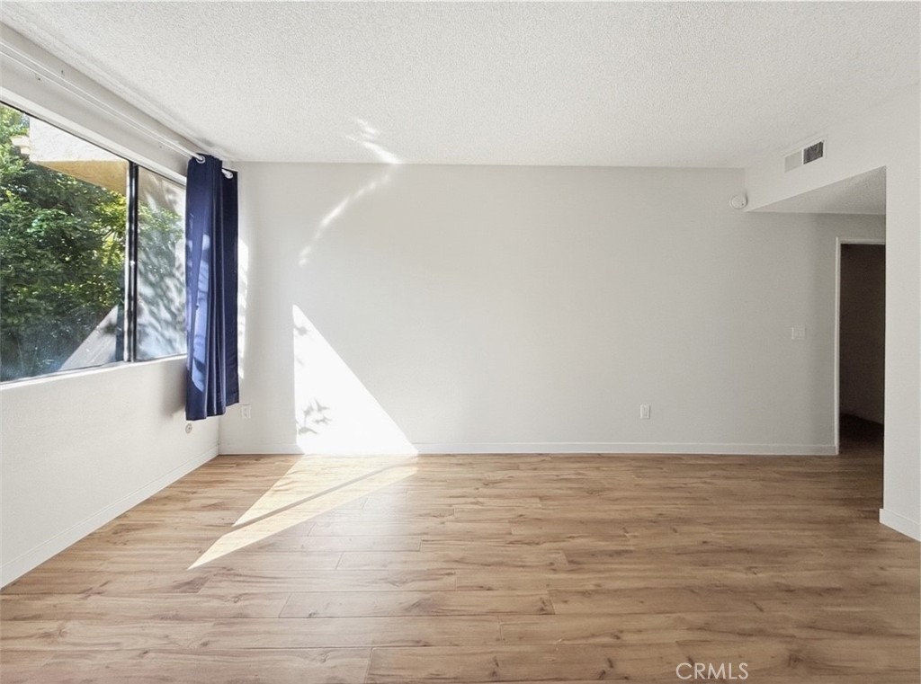 415 West Duarte Road, Unit 2 Arcadia, CA 91007 - Photo 19 of 30 a view of an empty room with wooden floor and a window